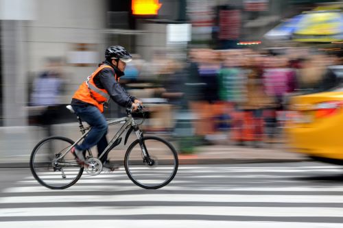 man riding a bike with a reflective vest