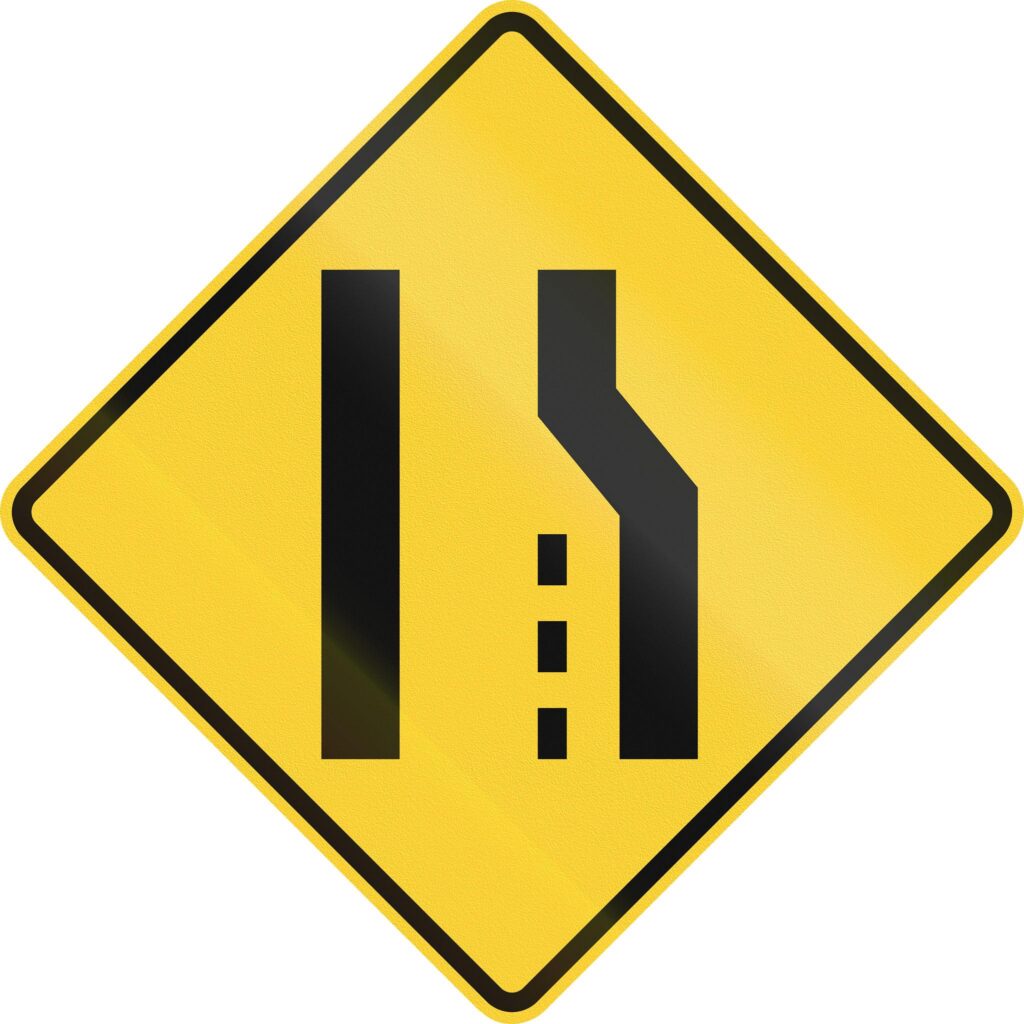 Narrow lane warning sign on American road indicating no shoulder and squeeze risk for cyclists following road signs for cyclists guidance