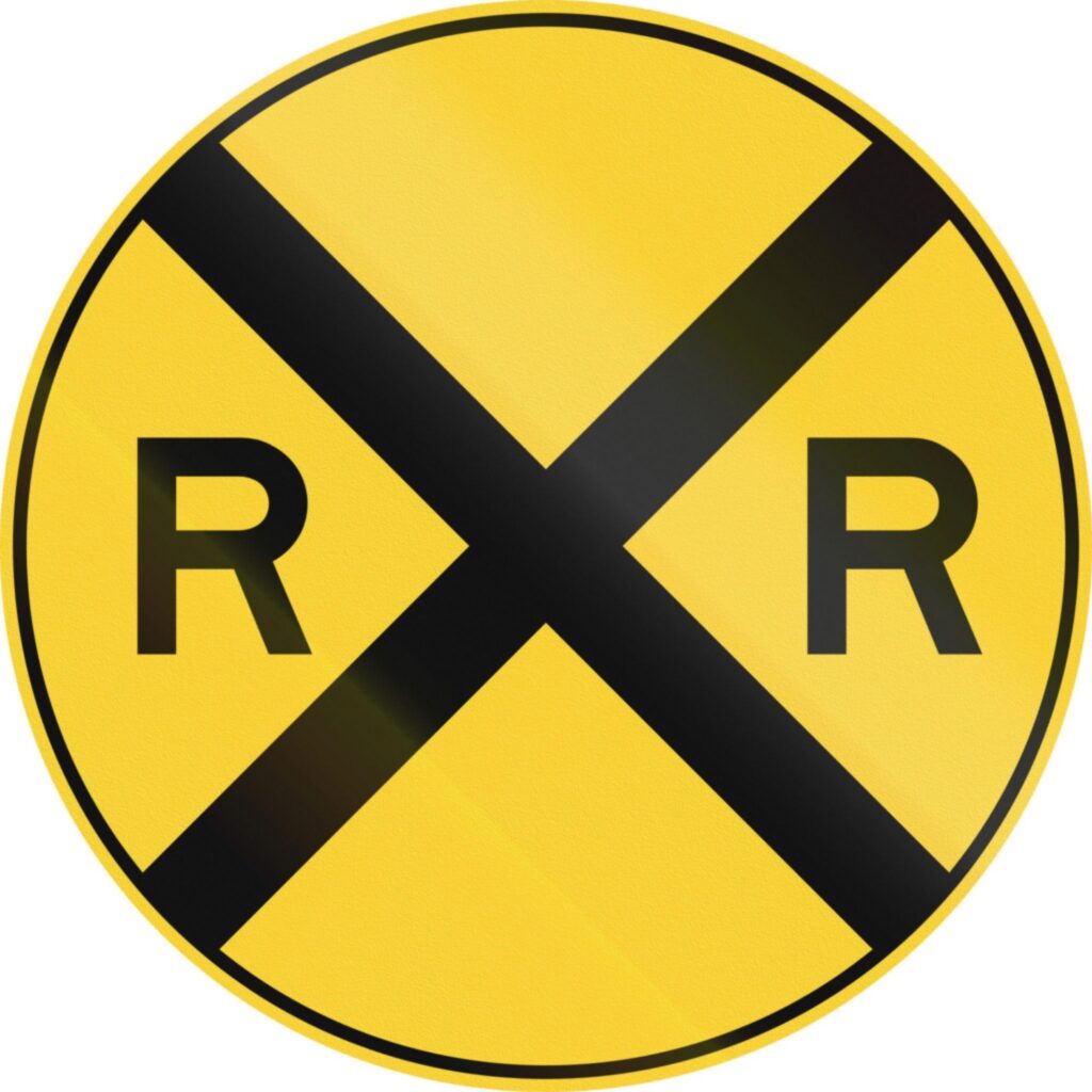 W10-1 railroad crossing warning sign at a road intersection relevant to bicycle warning signs guidance